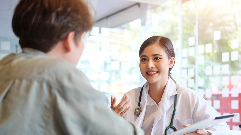 A doctor discussing with a patient in a medical setting.