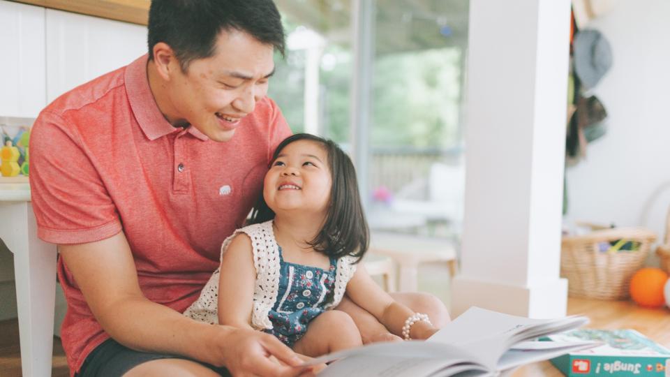 A man and a little girl engrossed in a book, sharing a special moment of reading together. Home Safety Hazards