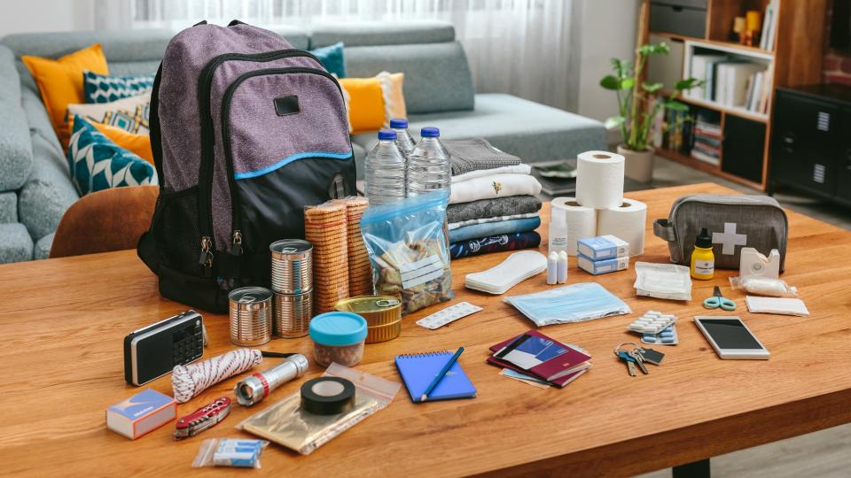 A backpack placed on a table alongside various items.