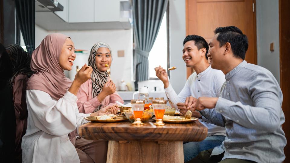 A family enjoying a meal together in the comfort of their home, sharing love, laughter, and delicious food.