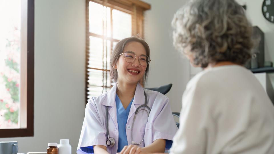 A female doctor discussing with a patient in a medical office.