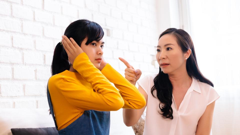 A woman and her daughter engaged in a heated argument, expressing their differing opinions and emotions.