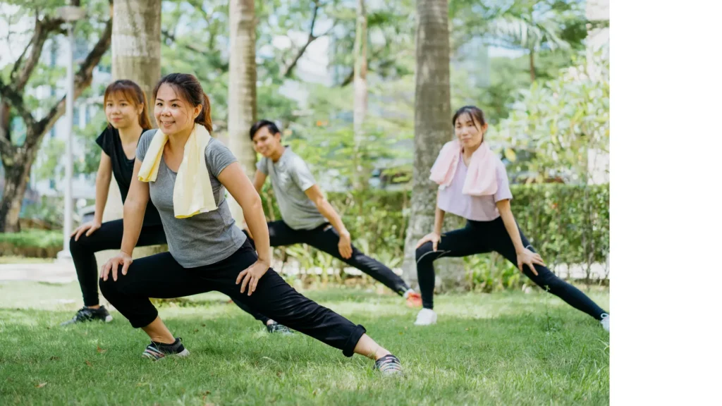 A group of women practicing yoga in the park, stretching and finding inner peace amidst nature's beauty.