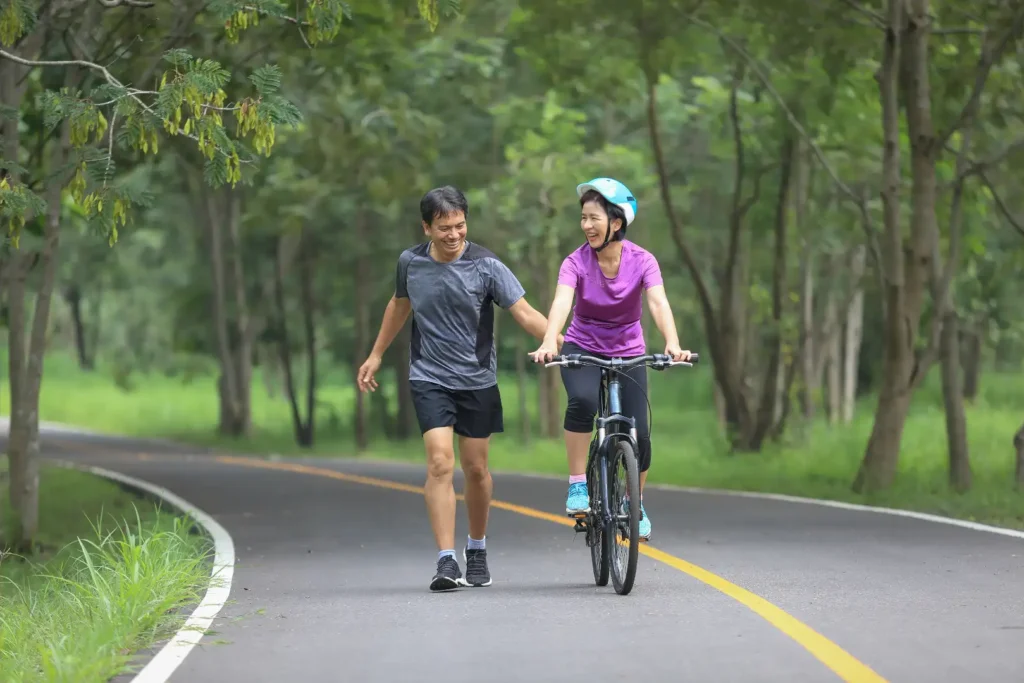 A couple cycling on a road.