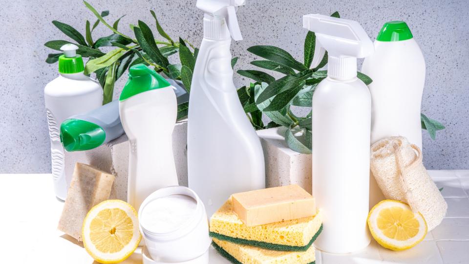 Cleaning products neatly arranged on a white counter, ready to tackle any mess.