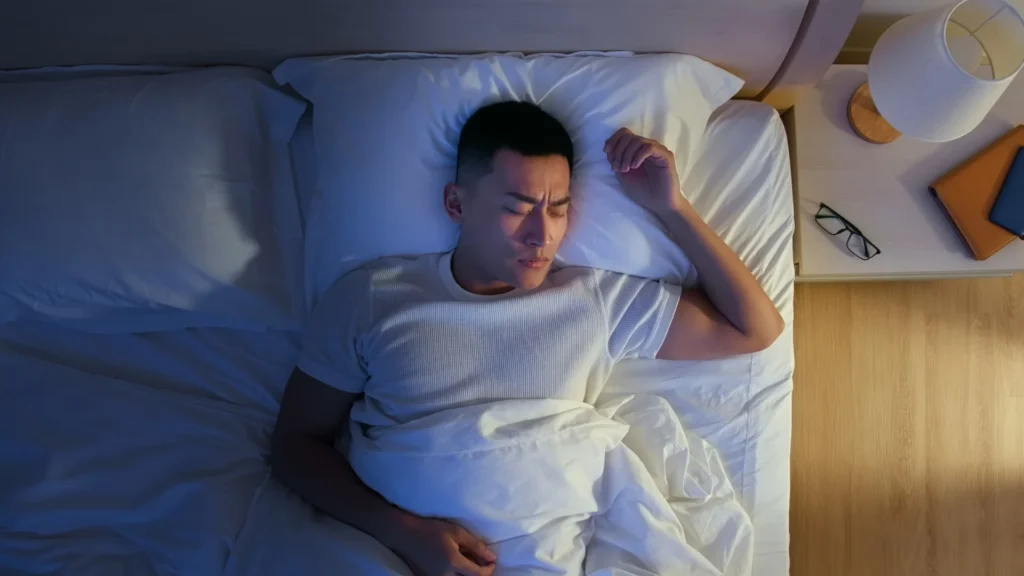 A man peacefully sleeping in bed, his eyes gently closed, enjoying a restful slumber. Insomnia