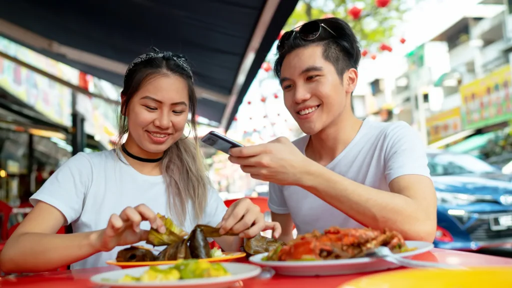 A couple enjoying a meal together at a table, surrounded by delicious food. Calories