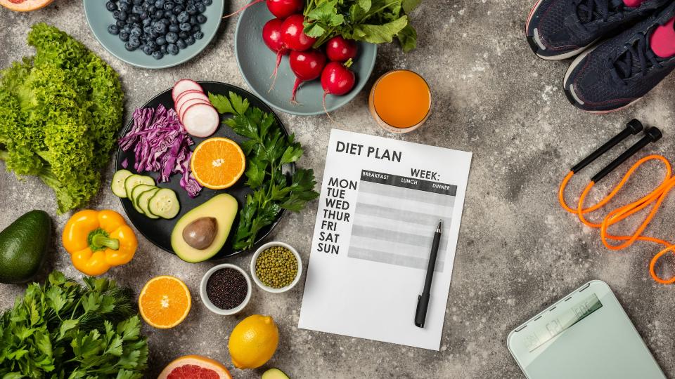 A nutritious diet plan featuring a variety of fruits and vegetables arranged on a table. Manage your weight