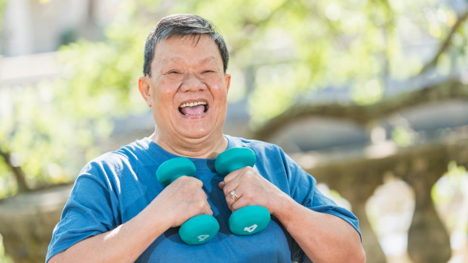 A man working out with dumbbells, focusing on his strength and fitness routine. Senior Wellness Tips
