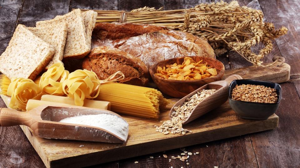 A delicious assortment of whole grains displayed on a rustic wooden table.