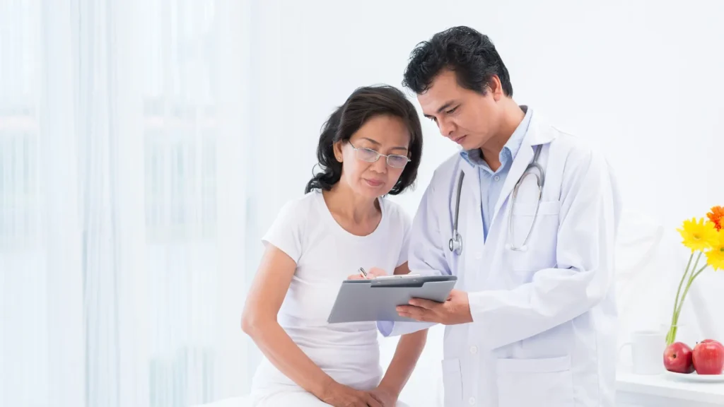 A doctor and patient discussing medical information on a tablet device. Abnormal Blood Tests