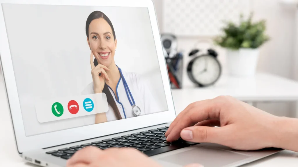 A person video chatting on a laptop. The Advantages and Disadvantages of Telemedicine