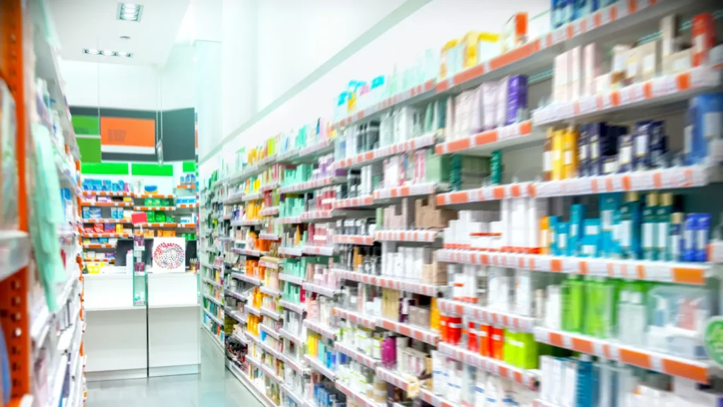 A pharmacy aisle with shelves stocked full of various health and wellness products.