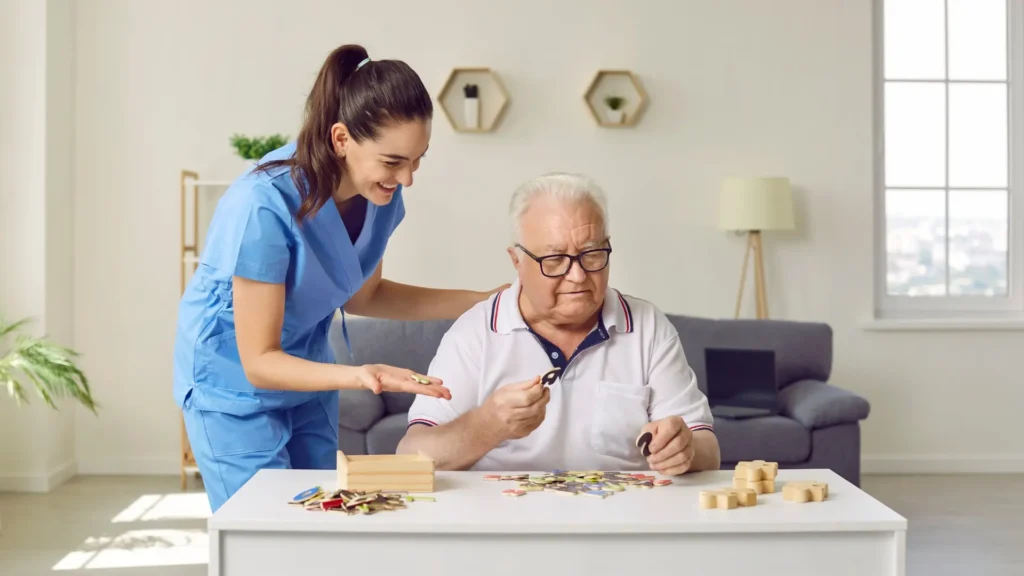 A nurse assisting an elderly man with a puzzle, providing compassionate care and support.