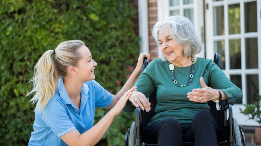 A woman in a wheelchair conversing with an older woman.