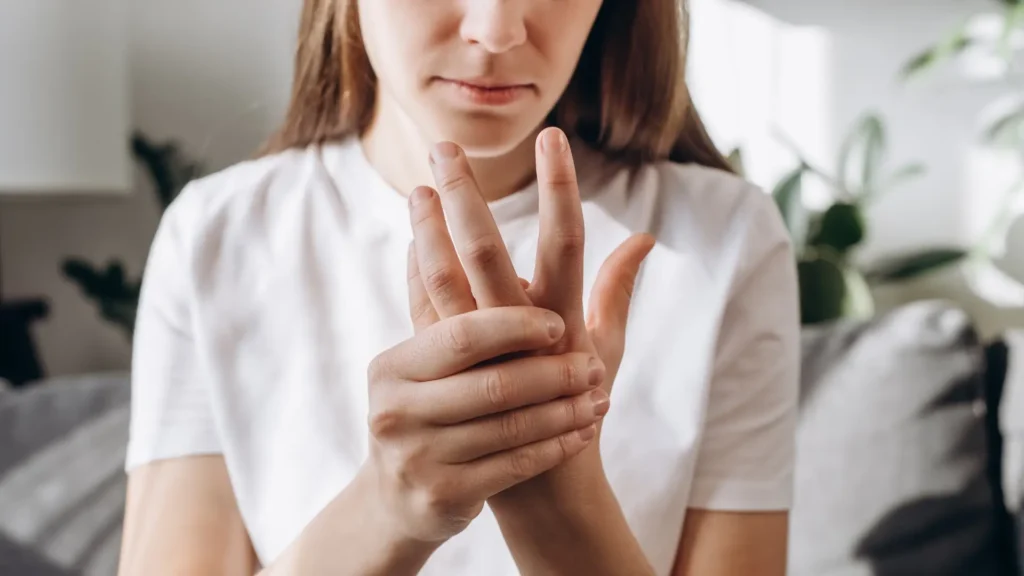 A woman clasping her hands together, showing unity and strength.