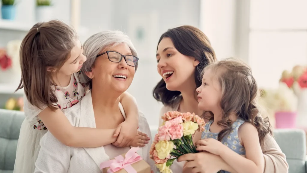 A smiling woman with two children and a grandmother, happy family moment.