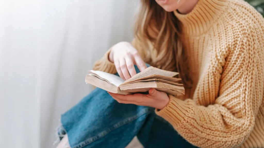 A mother reading the Best Postpartum Books