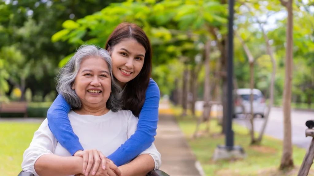 A caregiver and a woman in a wheel chair