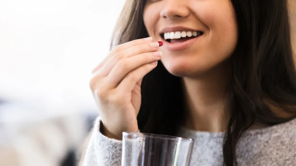 A woman eating the Best Period Supplements