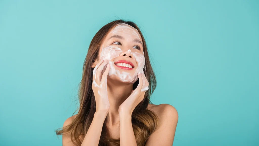 A young woman using the best vitamin C moisturizer