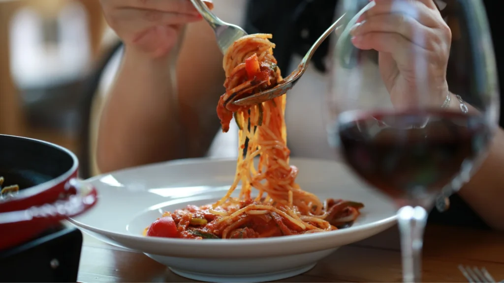 A woman eating the Best Gluten Free Pasta