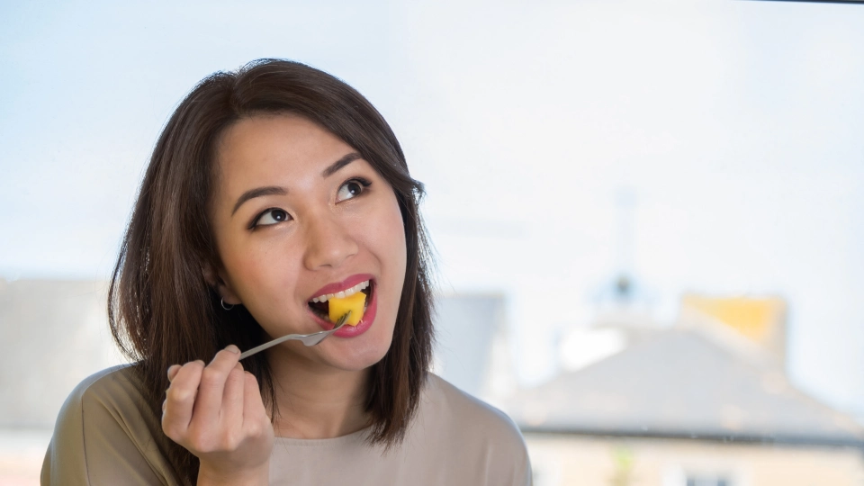 A woman eating the best low calorie fruits