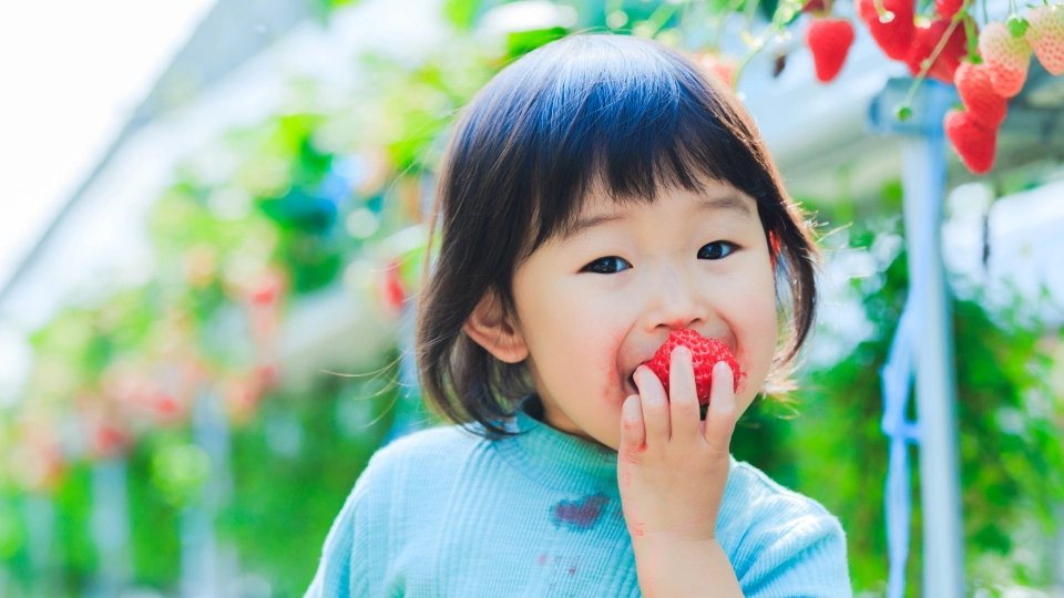 A toddler enjoying the best fruits for toddlers