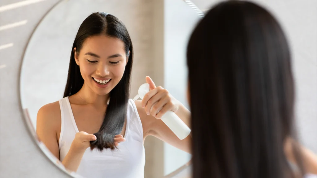 A woman using the best biotin shampoo for hair growth