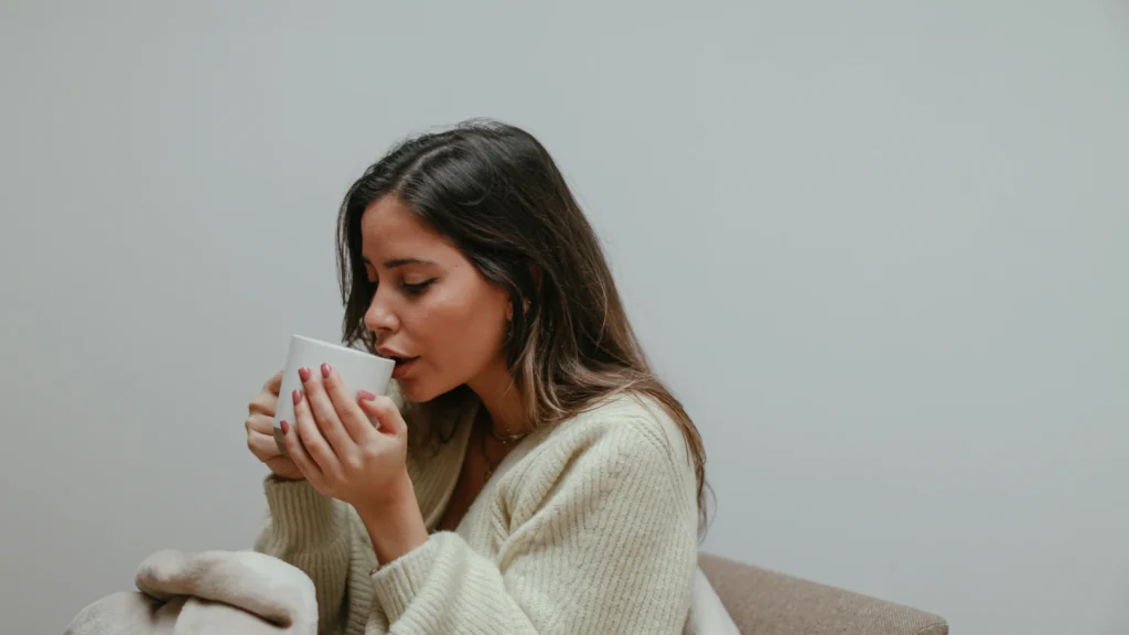 A lady drinking the best stress relief tea