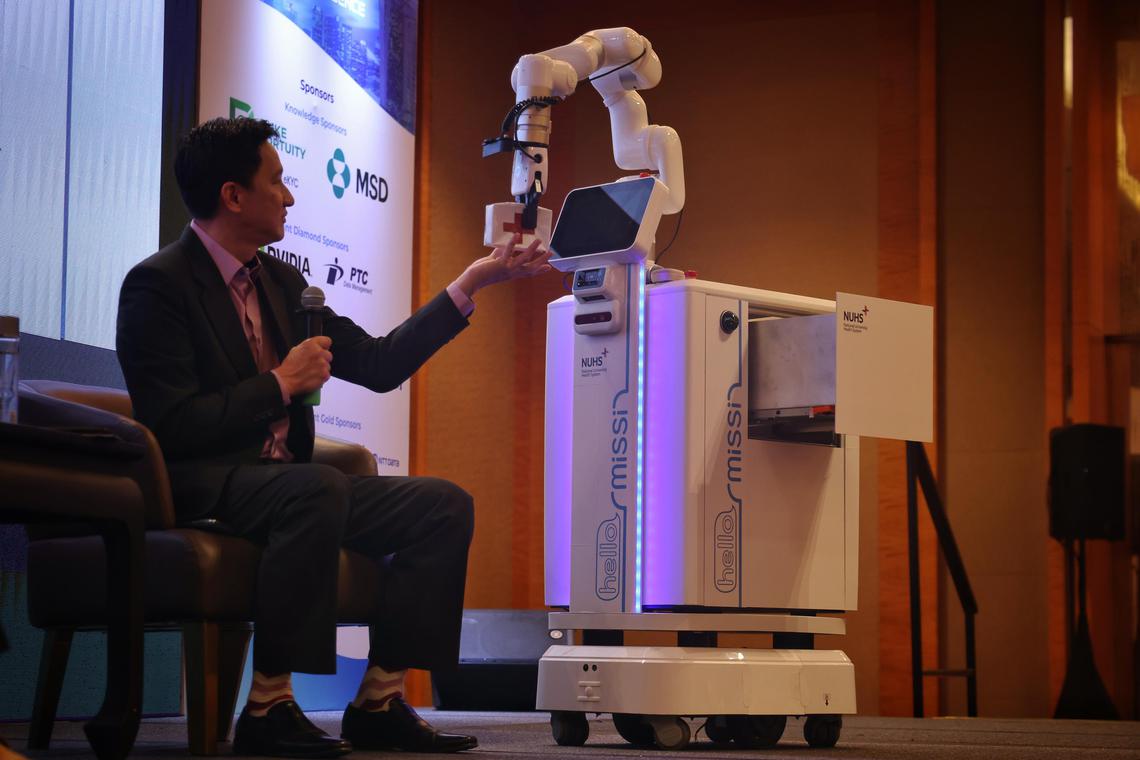 Demonstration of the Missi robot dispensing medicine at healthtech conference Imagine AI 2024 at Marina Bay Sands on Dec 5.