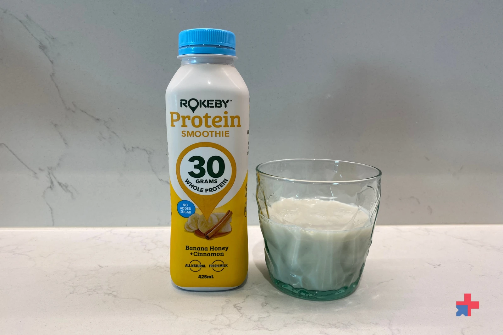 Yellow bottle of Rokeby Protein Smoothie Banana Honey Cinnamon flavor (30g protein) in a glass.